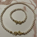 Pearl necklace with gold clasp on a marble surface