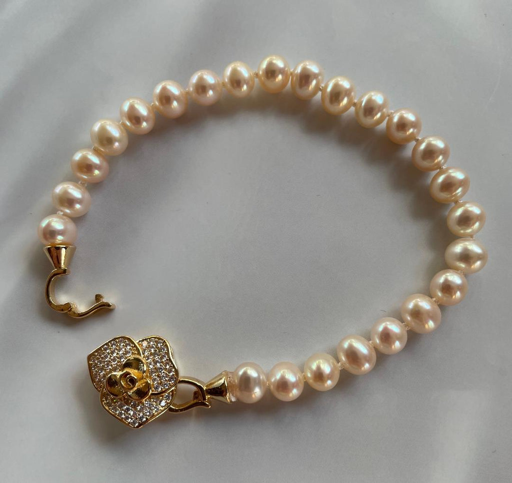 white freshwater pearl bracelet with gold flower clasp