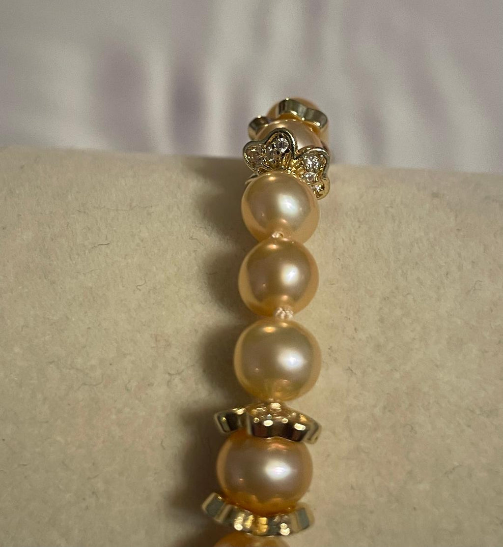 AA+ grade pink freshwater pearl hand-knotted bracelet with gold accents
